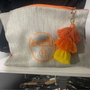 Canvas Pouch with H detail. Orange suede back. Tassel zipper closure